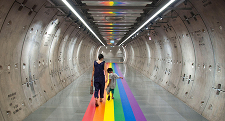 A woman and a kid walk along a rainbow flag decorated in the tunnel of the basement of Samyan Mitrtown shopping mall.Samyan Mitrtown, a mixed-use shopping, office, residential and leisure development celebrated the LGBTQ Pride Month 2021